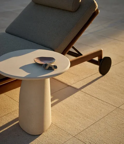 Poliform Strata table in travertine, catalog photograph